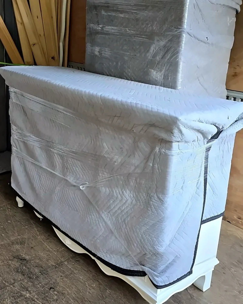 Furniture wrapped in protective covers inside the truck